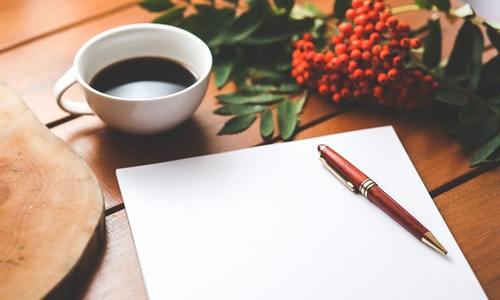 blank-paper-with-pen-and-coffee-cup-on-wood-table-6357